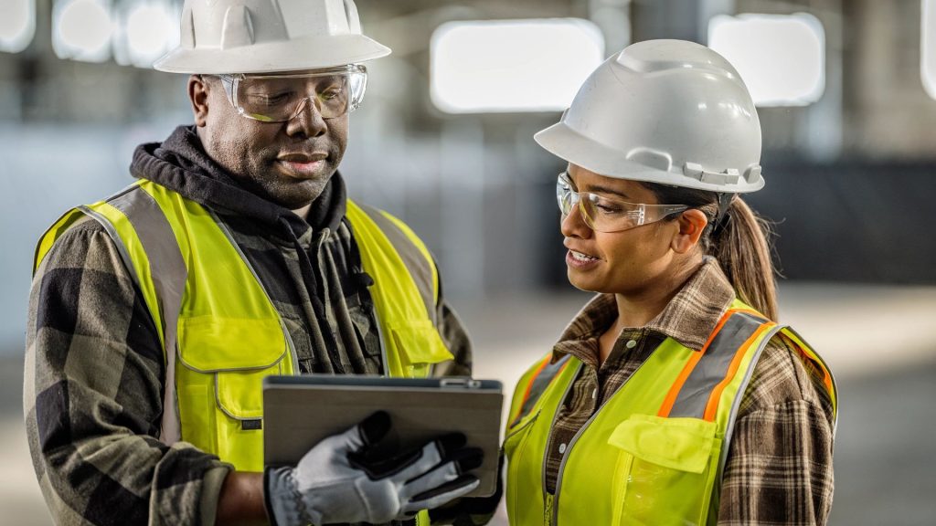 Construction workers and engineers at a Ugandan project site.
