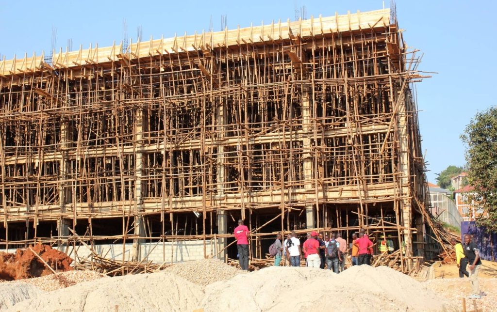 Builders working on a construction site in Uganda showing new job opportunities